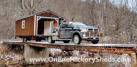 Hickory Shed being towed across an old bridge